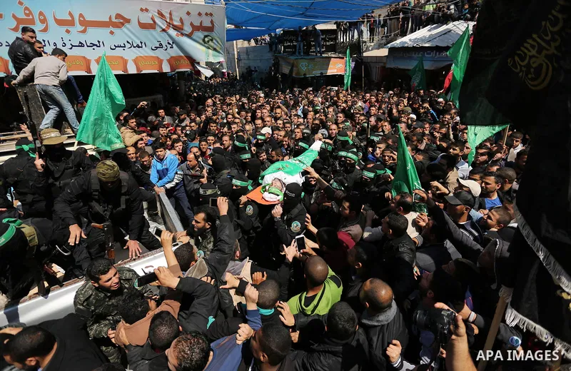 Members of the Ezzedine al-Qassam Brigades, the military wing of Hamas carry the body of Palestinian Islamist movement Hamas' official Mazen Faqha, during his funeral in Gaza city on March 25, 2017. Gunmen in the Gaza St...