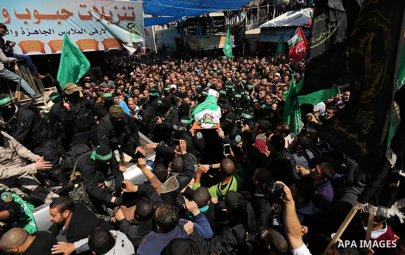 Members of the Ezzedine al-Qassam Brigades, the military wing of Hamas carry the body of Palestinian Islamist movement Hamas' official Mazen Faqha, during his funeral in Gaza city on March 25, 2017. Gunmen in the Gaza St...
