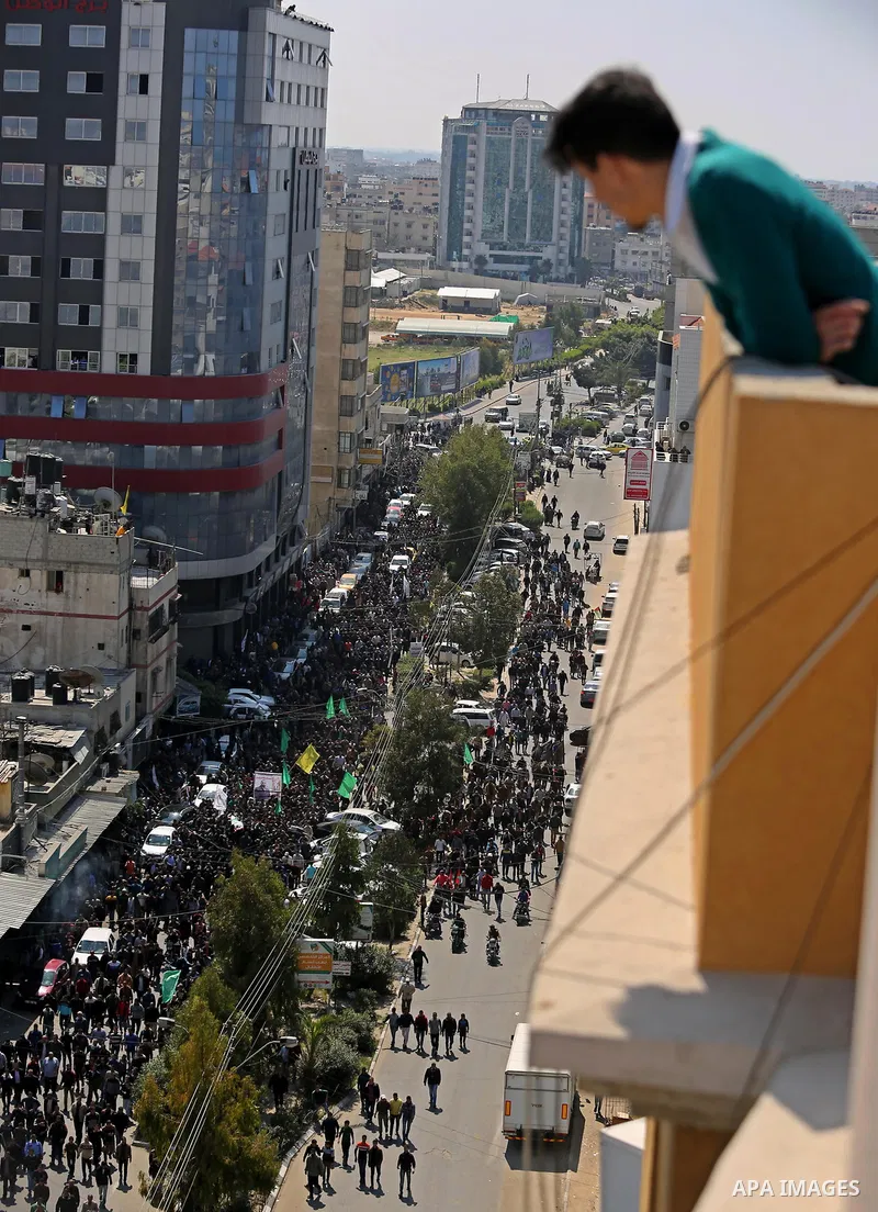 A Palestinian man watches the funeral of Palestinian Islamist movement Hamas' official Mazen Faqha, in Gaza city on March 25, 2017. Gunmen in the Gaza Strip had shot dead the Hamas official on March 24, 2017, according t...