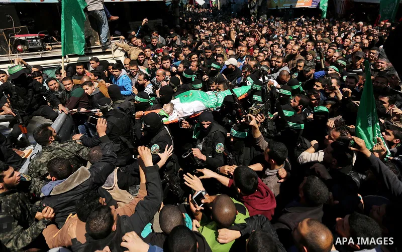 Members of the Ezzedine al-Qassam Brigades, the military wing of Hamas carry the body of Palestinian Islamist movement Hamas' official Mazen Faqha, during his funeral in Gaza city on March 25, 2017. Gunmen in the Gaza St...