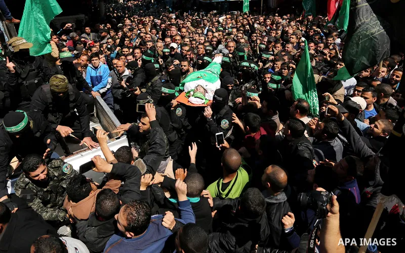 Members of the Ezzedine al-Qassam Brigades, the military wing of Hamas carry the body of Palestinian Islamist movement Hamas' official Mazen Faqha, during his funeral in Gaza city on March 25, 2017. Gunmen in the Gaza St...