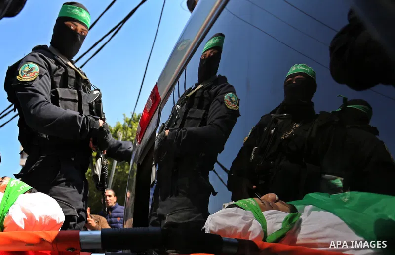 Members of the Ezzedine al-Qassam Brigades, the military wing of Hamas carry the body of Palestinian Islamist movement Hamas' official Mazen Faqha, during his funeral in Gaza city on March 25, 2017. Gunmen in the Gaza St...