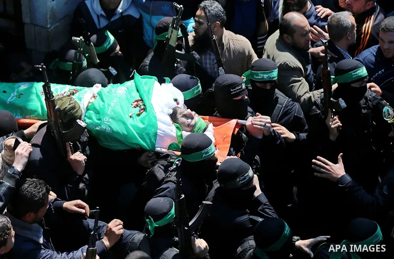 Members of the Ezzedine al-Qassam Brigades, the military wing of Hamas carry the body of Palestinian Islamist movement Hamas' official Mazen Faqha, during his funeral in Gaza city on March 25, 2017. Gunmen in the Gaza St...