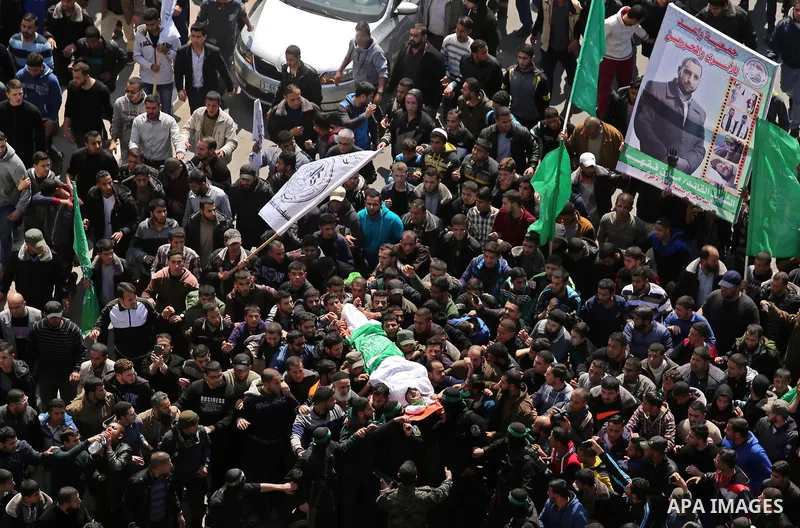 Members of the Ezzedine al-Qassam Brigades, the military wing of Hamas carry the body of Palestinian Islamist movement Hamas' official Mazen Faqha, during his funeral in Gaza city on March 25, 2017. Gunmen in the Gaza St...