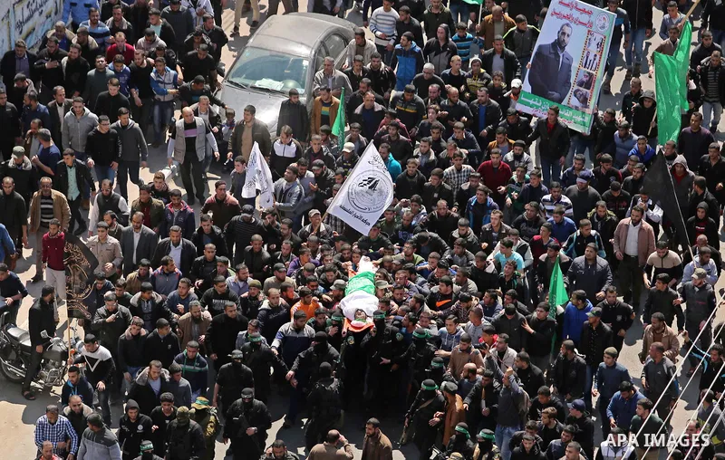 Members of the Ezzedine al-Qassam Brigades, the military wing of Hamas carry the body of Palestinian Islamist movement Hamas' official Mazen Faqha, during his funeral in Gaza city on March 25, 2017. Gunmen in the Gaza St...