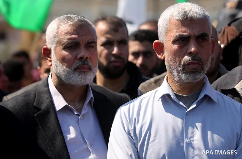 Yahya Sinwar, the new leader of Hamas in the Gaza Strip and senior political leaders of the Islamist movement, Ismail Haniyeh attend the funeral of Hamas official, Mazen Faqha in Gaza city on March 25, 2017. Gunmen in th...