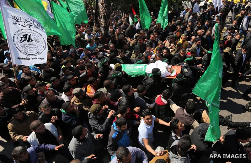 Members of the Ezzedine al-Qassam Brigades, the military wing of Hamas carry the body of Palestinian Islamist movement Hamas' official Mazen Faqha, during his funeral in Gaza city on March 25, 2017. Gunmen in the Gaza St...