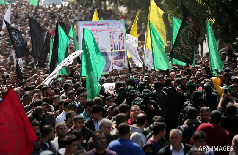 Members of the Ezzedine al-Qassam Brigades, the military wing of Hamas carry the body of Palestinian Islamist movement Hamas' official Mazen Faqha, during his funeral in Gaza city on March 25, 2017. Gunmen in the Gaza St...