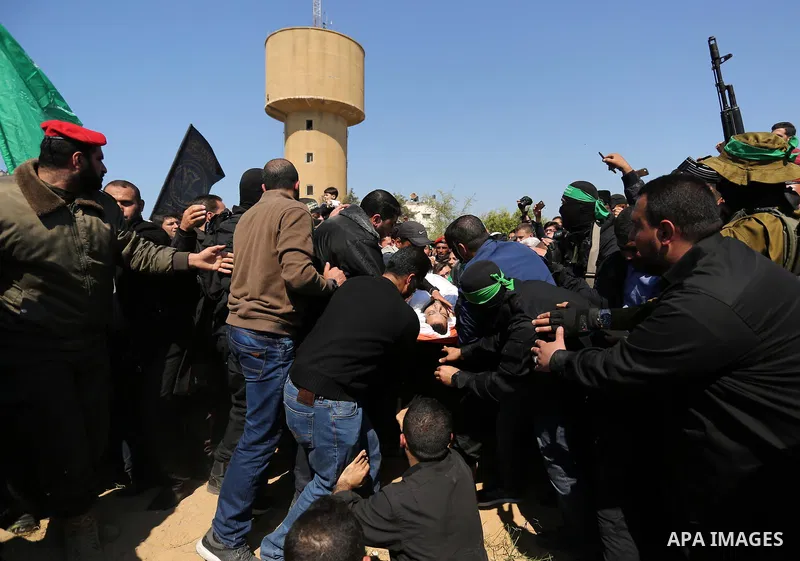 Palestinians bury the body of Hamas official, Mazen Faqha at a cemetery in Gaza City on March 25, 2017. Gunmen in the Gaza Strip had shot dead the Hamas official on March 24, 2017, according to Iyad al-Bozum, an interior...