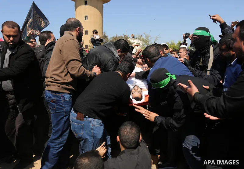 Palestinians bury the body of Hamas official, Mazen Faqha at a cemetery in Gaza City on March 25, 2017. Gunmen in the Gaza Strip had shot dead the Hamas official on March 24, 2017, according to Iyad al-Bozum, an interior...