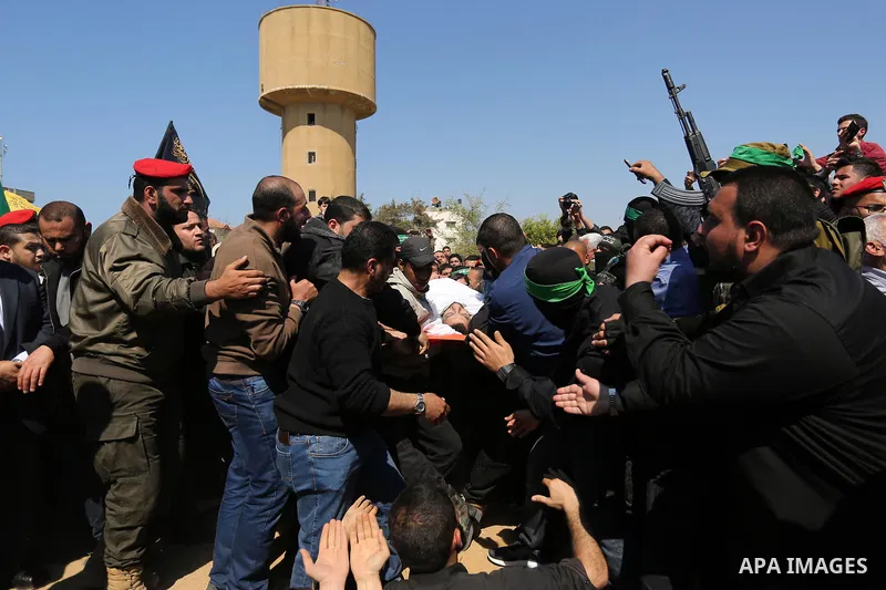 Palestinians bury the body of Hamas official, Mazen Faqha at a cemetery in Gaza City on March 25, 2017. Gunmen in the Gaza Strip had shot dead the Hamas official on March 24, 2017, according to Iyad al-Bozum, an interior...