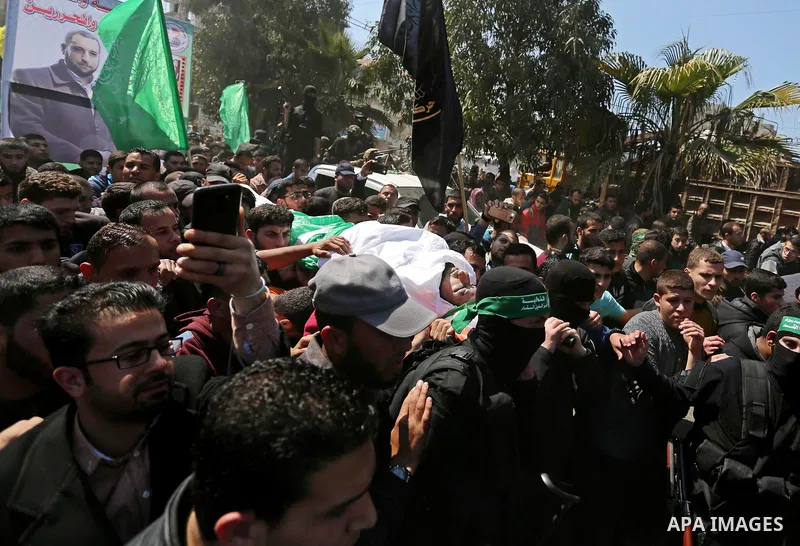 Members of the Ezzedine al-Qassam Brigades, the military wing of Hamas carry the body of Palestinian Islamist movement Hamas' official Mazen Faqha, during his funeral in Gaza city on March 25, 2017. Gunmen in the Gaza St...