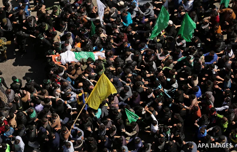 Members of the Ezzedine al-Qassam Brigades, the military wing of Hamas carry the body of Palestinian Islamist movement Hamas' official Mazen Faqha, during his funeral in Gaza city on March 25, 2017. Gunmen in the Gaza St...