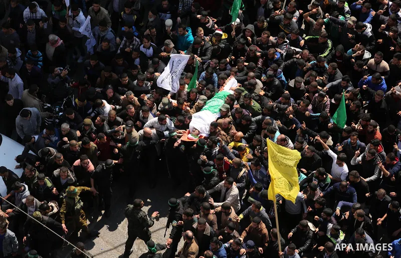 Members of the Ezzedine al-Qassam Brigades, the military wing of Hamas carry the body of Palestinian Islamist movement Hamas' official Mazen Faqha, during his funeral in Gaza city on March 25, 2017. Gunmen in the Gaza St...