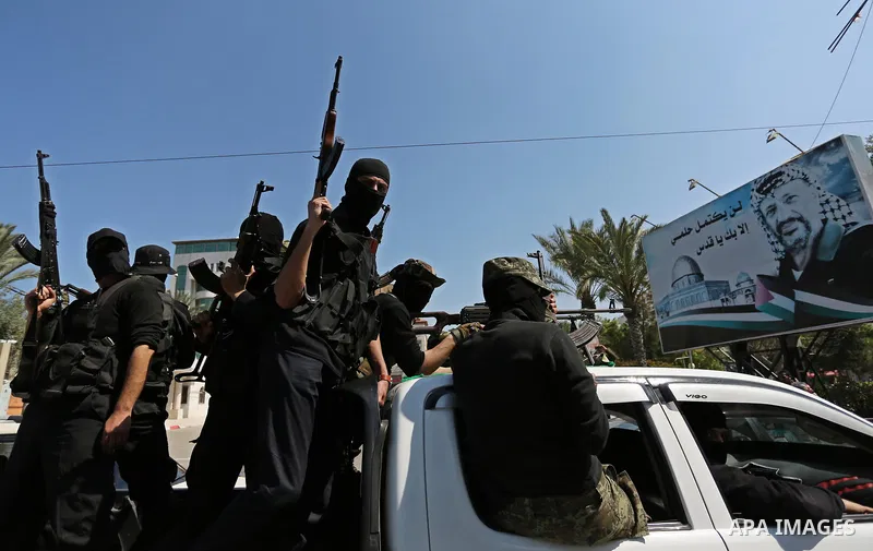 Members of the Ezzedine al-Qassam Brigades, the military wing of the Palestinian Islamist movement Hamas take part in the funeral of Hamas official, Mazen Faqha who was freed by Israel in a 2011 prisoner swap in Gaza Cit...