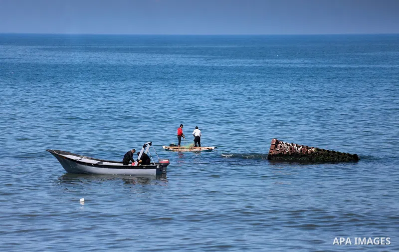 Palestinian fishermen ride their fishing boat during a Navy patrol at the beach of Gaza City on March 26, 2017, after it was shut by the Islamist movement after blaming the Jewish state for the assassination of one of it...