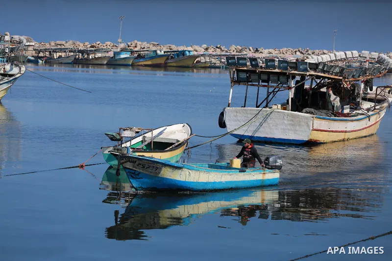 Palestinian fishermen ride their fishing boat during a Navy patrol at the beach of Gaza City on March 26, 2017, after it was shut by the Islamist movement after blaming the Jewish state for the assassination of one of it...