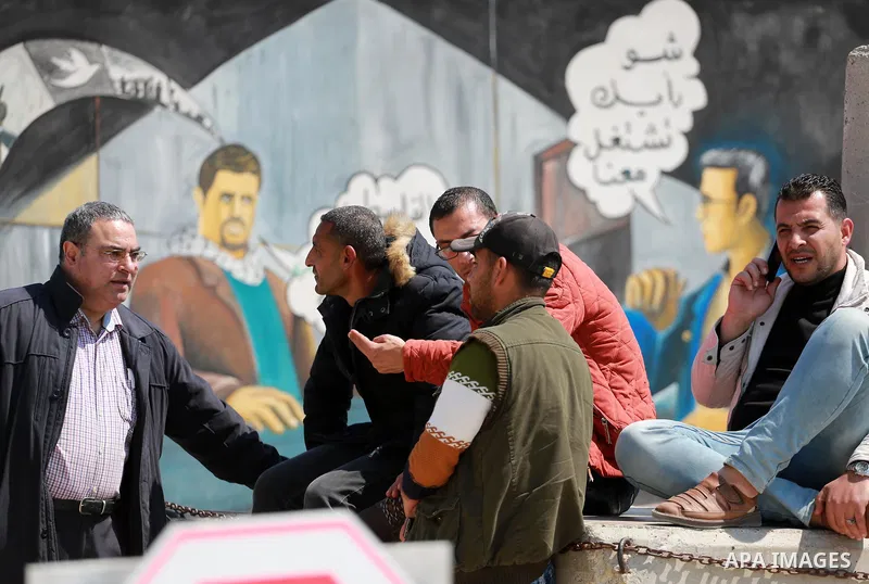 Palestinians wait at Erez border crossing into Israel, in Beit Hanun, in the northern Gaza Strip on March 26, 2017, after it was shut by the Islamist movement after blaming the Jewish state for the assassination of one o...