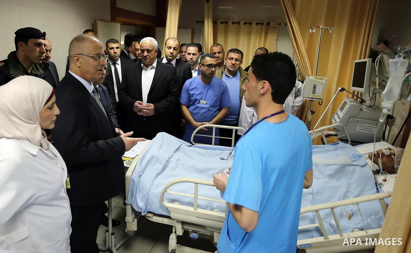 Palestinian Prime Minister Rami Hamdallah visits Palestinians who wounded during clashes with Israeli security forces at Palestine medical complex, in the West Bank city of Ramallah, on March 26, 2017. Photo by Prime Min...