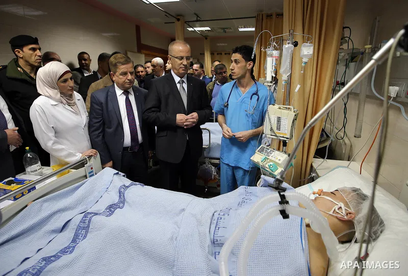 Palestinian Prime Minister Rami Hamdallah visits Palestinians who wounded during clashes with Israeli security forces at Palestine medical complex, in the West Bank city of Ramallah, on March 26, 2017. Photo by Prime Min...