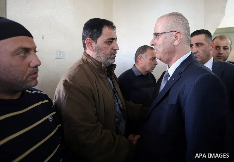 Palestinian Prime Minister Rami Hamdallah offers his condolences for the family of Mohammed Hattab who was shot dead by Israeli security forces at the al-Jalazun refugee camp, near the West Bank city of Ramallah, on Marc...