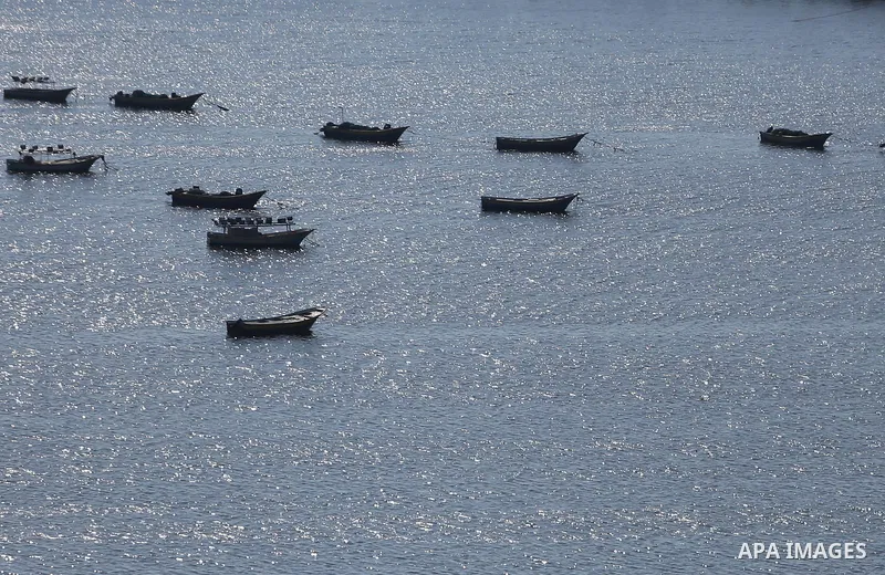 Palestinian fishermen ride their fishing boat at the beach of Gaza City on March 26, 2017, after the Islamist movement shut Erez border crossing and all borders, including its western sea border after blaming the Jewish...