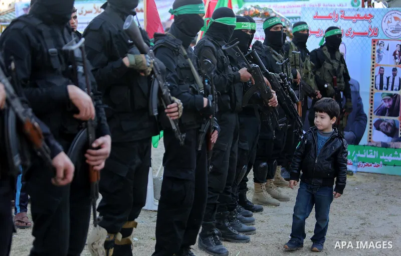Members of the Ezzedine al-Qassam Brigades, the military wing of the Palestinian Islamist movement Hamas take part in condolences of Hamas official, Mazen Faqha who was freed by Israel in a 2011 prisoner swap after shot...