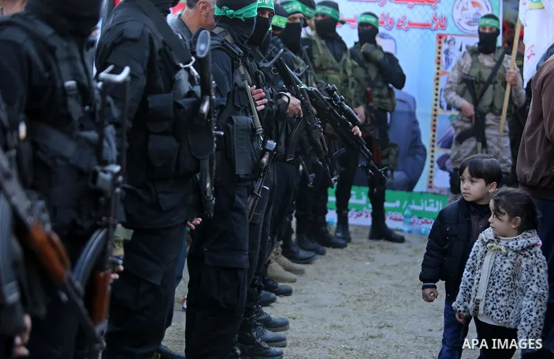 Members of the Ezzedine al-Qassam Brigades, the military wing of the Palestinian Islamist movement Hamas take part in condolences of Hamas official, Mazen Faqha who was freed by Israel in a 2011 prisoner swap after shot...