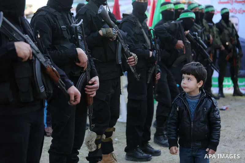 Members of the Ezzedine al-Qassam Brigades, the military wing of the Palestinian Islamist movement Hamas take part in condolences of Hamas official, Mazen Faqha who was freed by Israel in a 2011 prisoner swap after shot...
