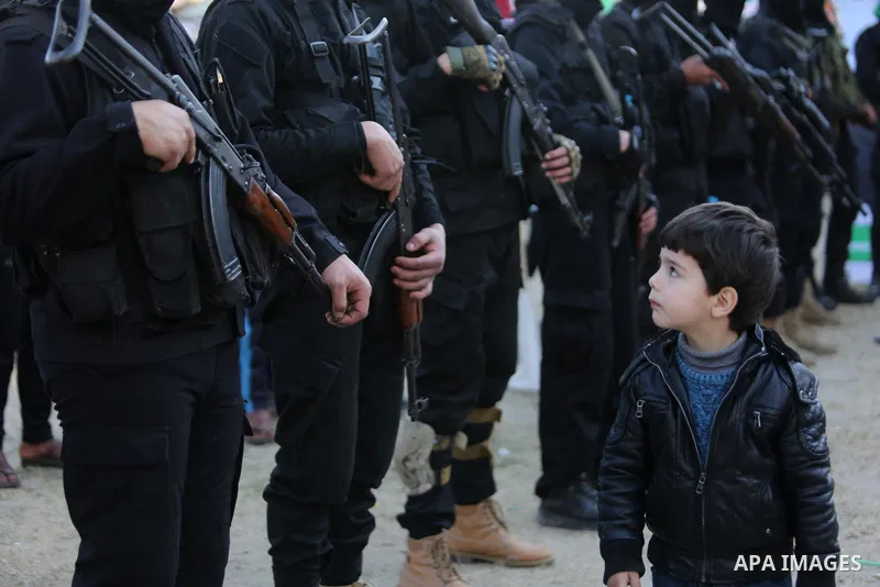 Members of the Ezzedine al-Qassam Brigades, the military wing of the Palestinian Islamist movement Hamas take part in condolences of Hamas official, Mazen Faqha who was freed by Israel in a 2011 prisoner swap after shot...