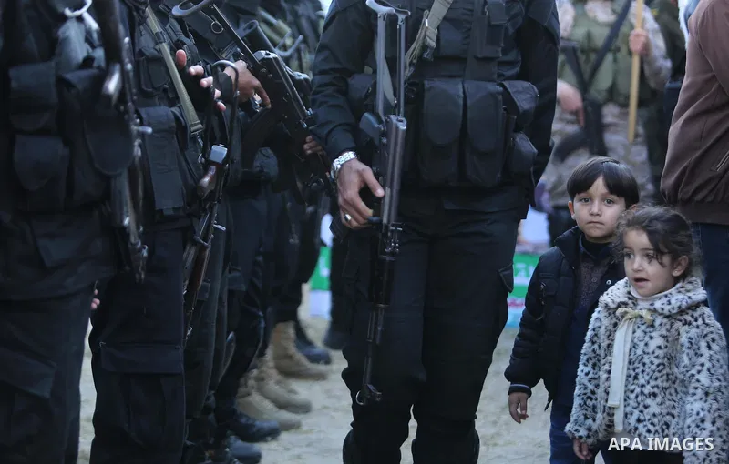Members of the Ezzedine al-Qassam Brigades, the military wing of the Palestinian Islamist movement Hamas take part in condolences of Hamas official, Mazen Faqha who was freed by Israel in a 2011 prisoner swap after shot...