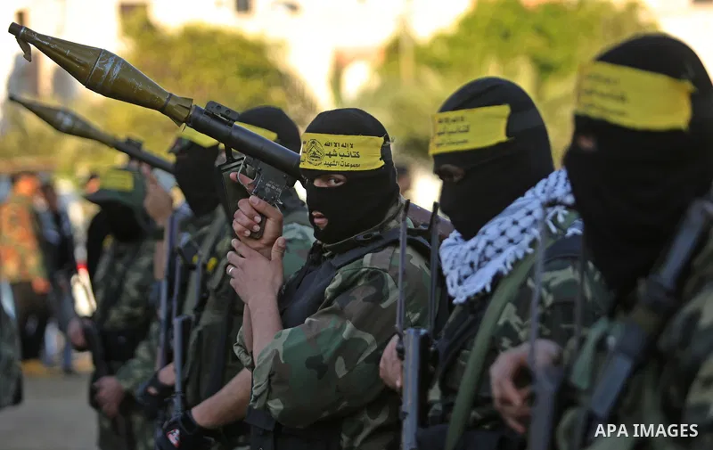 Palestinian militants of Al-Aqsa Martyrs' Brigades, a group linked to the Fatah movement take part in condolences of Hamas official, Mazen Faqha who was freed by Israel in a 2011 prisoner swap after shot dead by gunmen y...