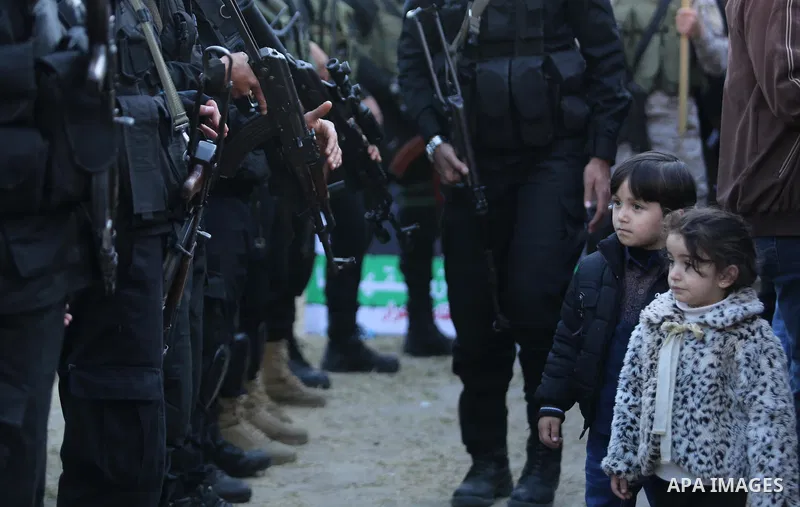 Members of the Ezzedine al-Qassam Brigades, the military wing of the Palestinian Islamist movement Hamas take part in condolences of Hamas official, Mazen Faqha who was freed by Israel in a 2011 prisoner swap after shot...