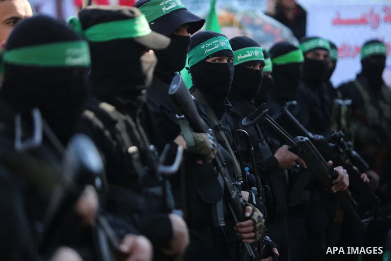 Members of the Ezzedine al-Qassam Brigades, the military wing of the Palestinian Islamist movement Hamas take part in condolences of Hamas official, Mazen Faqha who was freed by Israel in a 2011 prisoner swap after shot...