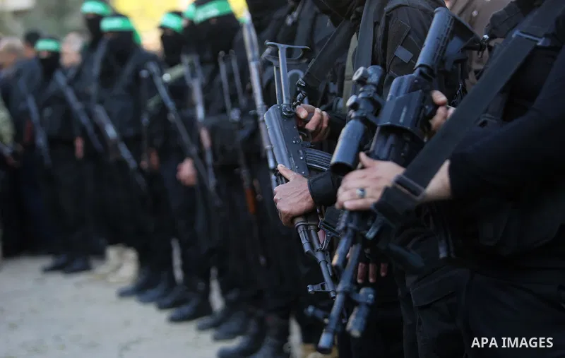 Members of the Ezzedine al-Qassam Brigades, the military wing of the Palestinian Islamist movement Hamas take part in condolences of Hamas official, Mazen Faqha who was freed by Israel in a 2011 prisoner swap after shot...
