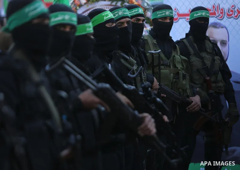Members of the Ezzedine al-Qassam Brigades, the military wing of the Palestinian Islamist movement Hamas take part in condolences of Hamas official, Mazen Faqha who was freed by Israel in a 2011 prisoner swap after shot...