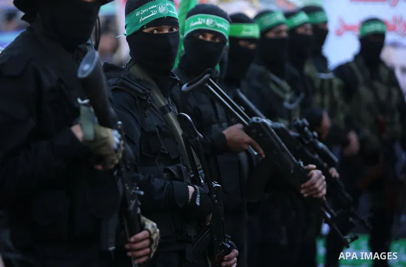 Members of the Ezzedine al-Qassam Brigades, the military wing of the Palestinian Islamist movement Hamas take part in condolences of Hamas official, Mazen Faqha who was freed by Israel in a 2011 prisoner swap after shot...