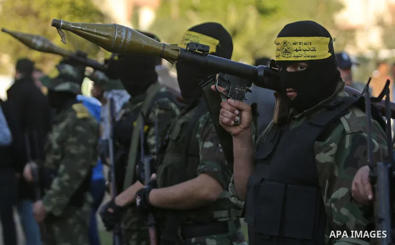 Palestinian militants of Al-Aqsa Martyrs' Brigades, a group linked to the Fatah movement take part in condolences of Hamas official, Mazen Faqha who was freed by Israel in a 2011 prisoner swap after shot dead by gunmen y...