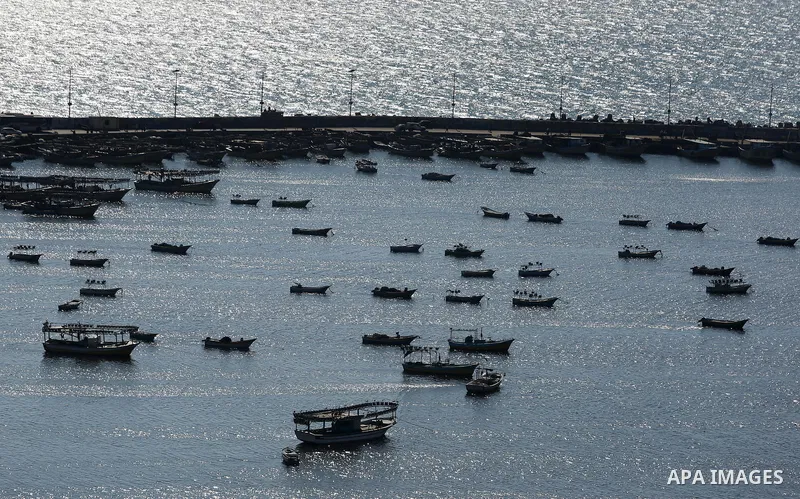 Palestinian fishermen ride their fishing boat at the beach of Gaza City on March 26, 2017, after the Islamist movement shut Erez border crossing and all borders, including its western sea border after blaming the Jewish...