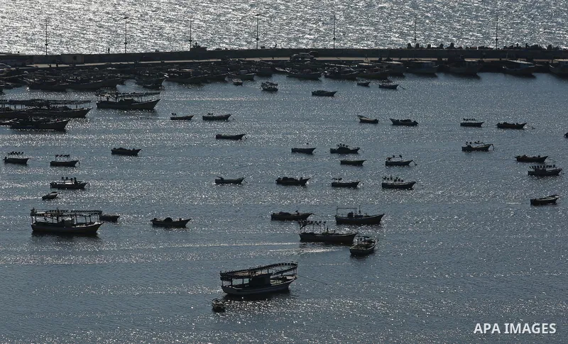 Palestinian fishermen ride their fishing boat at the beach of Gaza City on March 26, 2017, after the Islamist movement shut Erez border crossing and all borders, including its western sea border after blaming the Jewish...