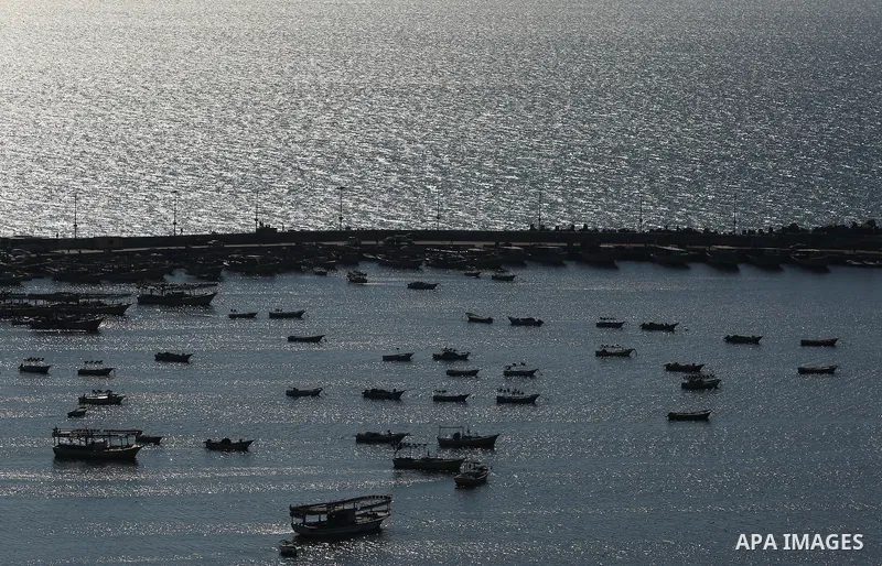 Palestinian fishermen ride their fishing boat at the beach of Gaza City on March 26, 2017, after the Islamist movement shut Erez border crossing and all borders, including its western sea border after blaming the Jewish...
