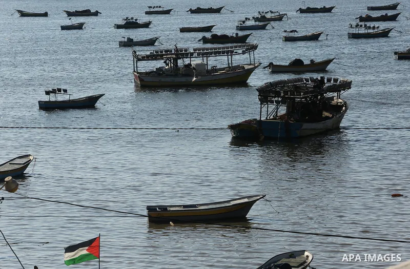 Palestinian fishermen ride their fishing boat at the beach of Gaza City on March 26, 2017, after the Islamist movement shut Erez border crossing and all borders, including its western sea border after blaming the Jewish...