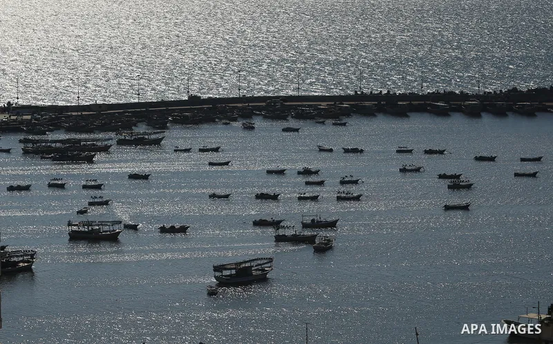 Palestinian fishermen ride their fishing boat at the beach of Gaza City on March 26, 2017, after the Islamist movement shut Erez border crossing and all borders, including its western sea border after blaming the Jewish...