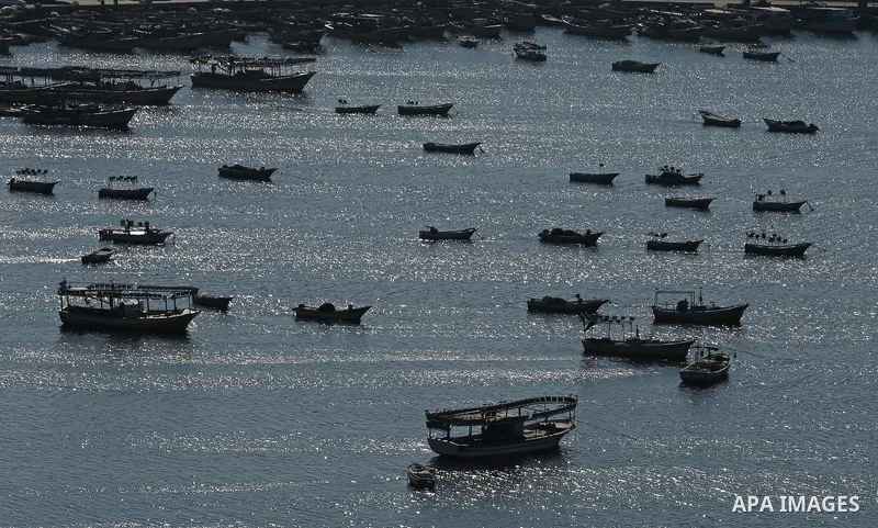 Palestinian fishermen ride their fishing boat at the beach of Gaza City on March 26, 2017, after the Islamist movement shut Erez border crossing and all borders, including its western sea border after blaming the Jewish...