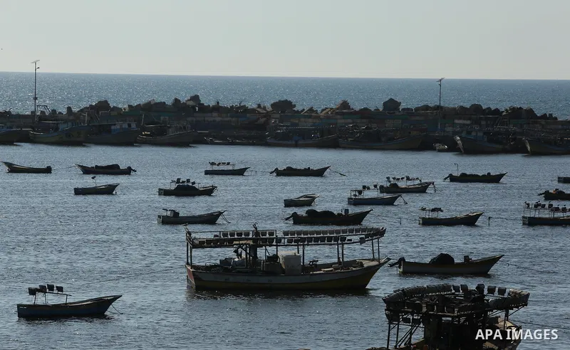 Palestinian fishermen ride their fishing boat at the beach of Gaza City on March 26, 2017, after the Islamist movement shut Erez border crossing and all borders, including its western sea border after blaming the Jewish...
