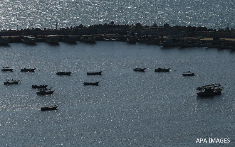 Palestinian fishermen ride their fishing boat at the beach of Gaza City on March 26, 2017, after the Islamist movement shut Erez border crossing and all borders, including its western sea border after blaming the Jewish...