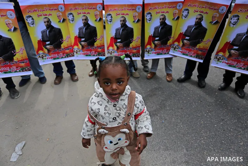 Palestinians take part during a protest denouncing an assassination of Hamas official, Mazen Faqha who was freed by Israel in a 2011 prisoner swap after he was shot dead by unknown gunmen, in front of Red cross office in...