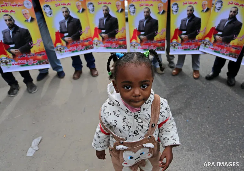 Palestinians take part during a protest denouncing an assassination of Hamas official, Mazen Faqha who was freed by Israel in a 2011 prisoner swap after he was shot dead by unknown gunmen, in front of Red cross office in...