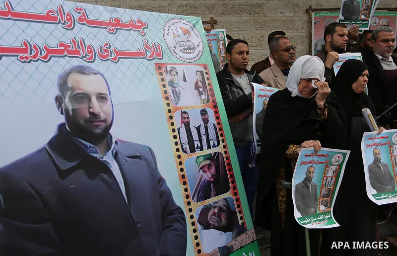 Palestinians take part during a protest denouncing an assassination of Hamas official, Mazen Faqha who was freed by Israel in a 2011 prisoner swap after he was shot dead by unknown gunmen, in front of Red cross office in...