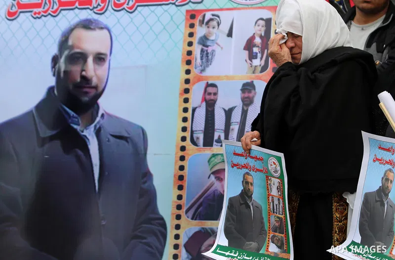 Palestinians take part during a protest denouncing an assassination of Hamas official, Mazen Faqha who was freed by Israel in a 2011 prisoner swap after he was shot dead by unknown gunmen, in front of Red cross office in...